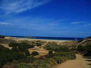 Scenic view of beach against cloudy sky