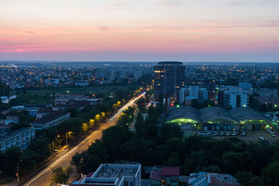Aerial view of city lit up at sunset