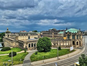 Buildings in city against cloudy sky