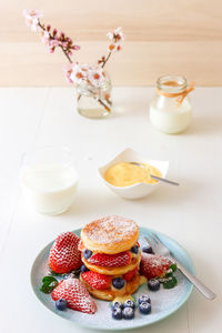 Mille feuille, high angle view of french dessert on table with summer berry fruits and lemon curd.