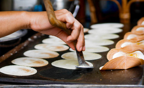 Midsection of person preparing food