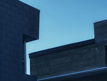 Low angle view of modern building against clear blue sky