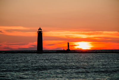 Silhouette of lighthouse at sunset