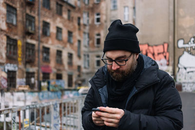 Man using mobile phone in city