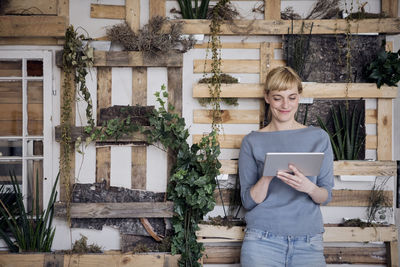 Smiling woman using tablet