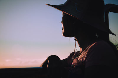 Close-up of silhouette woman against sky during sunset