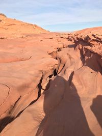 Sand dunes in desert against sky