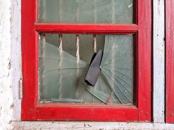 Close-up of window on red wall