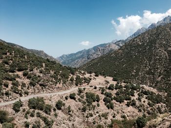 Scenic view of mountains against blue sky