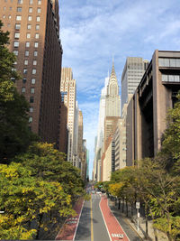 Panoramic view of road amidst buildings against sky