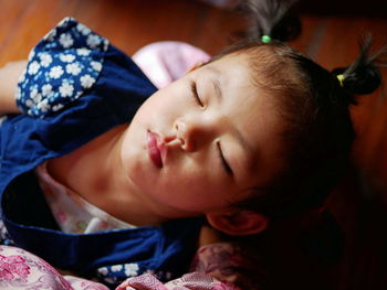 Close-up of cute girl sleeping at home