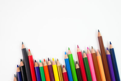 Close-up of colored pencils against white background