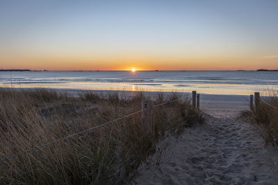 Scenic view of sea against clear sky during sunset