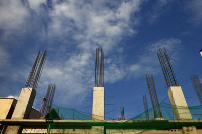 Unfinished concrete with steel bar pillars at a construction site