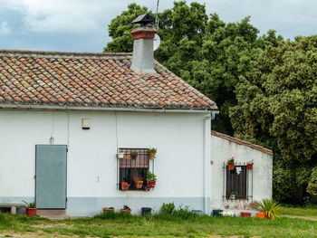 House by building against sky