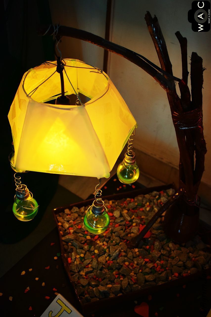 LOW ANGLE VIEW OF LANTERNS HANGING ON WALL