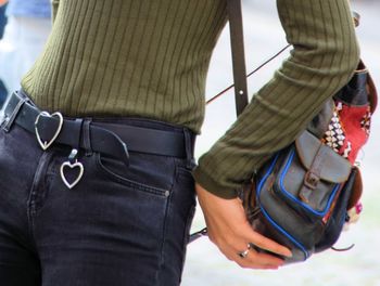 Rear view of woman with umbrella standing against blurred background