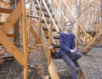 Portrait of young man sitting on playground