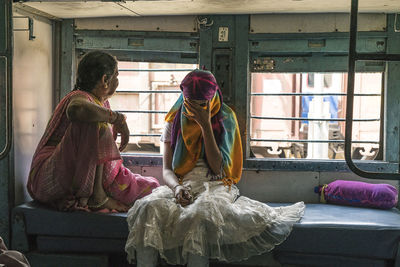 Women sitting on window