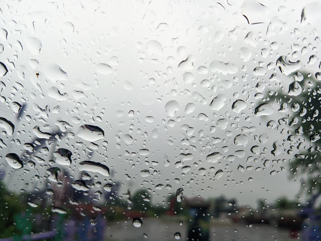 drop, wet, window, rain, glass, water, transparent, drizzle, raindrop, rainy season, nature, full frame, no people, indoors, freezing, snow, close-up, car, mode of transportation, transportation, backgrounds, monsoon, motor vehicle, focus on foreground, day, sky, vehicle interior, city, looking, land vehicle, architecture