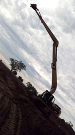 View of crane against cloudy sky