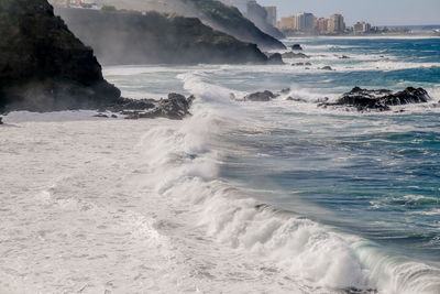 Waves splashing on rocks at shore