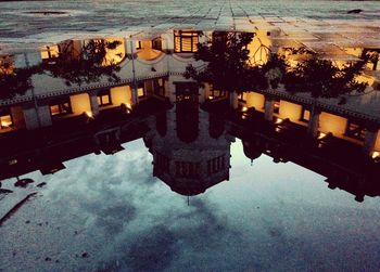 Reflection of city on river during sunset