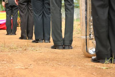 Low section of people standing on land