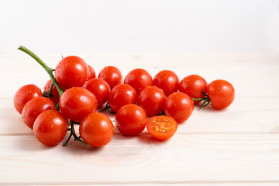 Close-up of tomatoes on table against white background