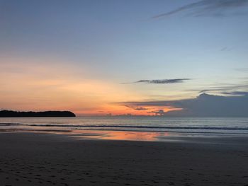 Scenic view of beach against sky during sunset