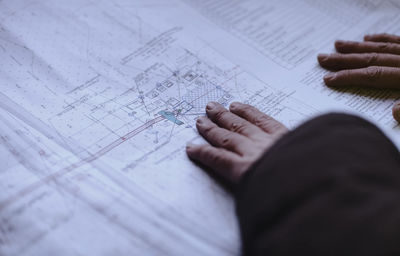 High angle view of man working on paper