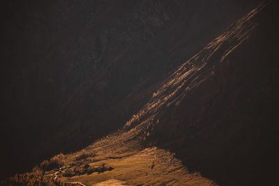 Colorful larch trees and layers of mountain ridges in the austrian alps in autumn.