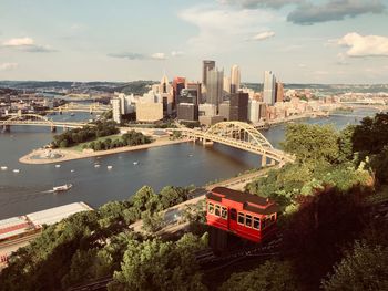 High angle view of buildings by sea against sky