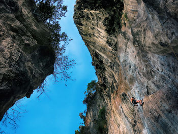 Tourists on rock formation in sea