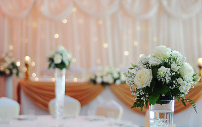 White roses in vase on table