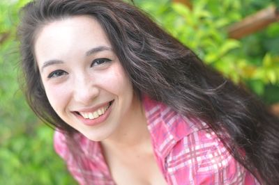 Portrait of smiling young woman with black hair