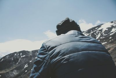 Rear view of person in snow against sky