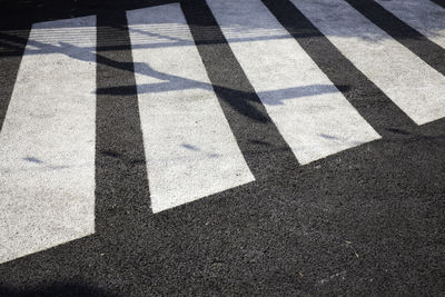 Shadow of person on street