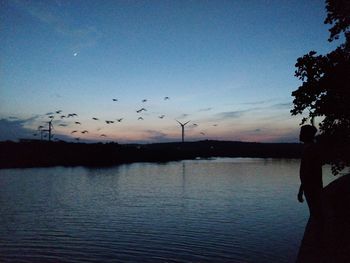 Scenic view of lake against sky during sunset