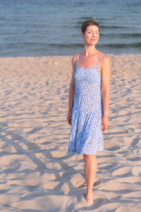 Young woman standing at beach