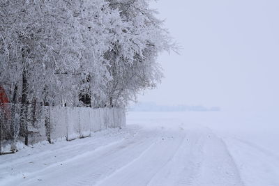 Snow covered field against sky