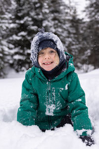 Portrait of young woman skiing on snow