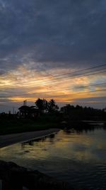 Scenic view of lake against orange sky