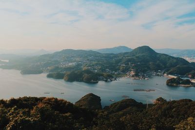 Scenic view of sea and mountains against sky