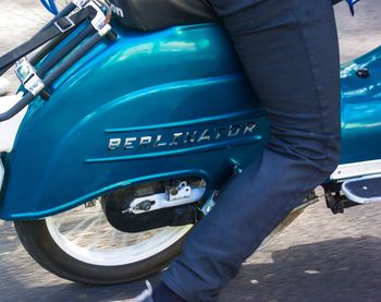 Low section of man standing on bus