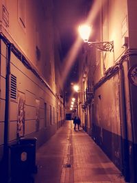 Illuminated street lights in city at night