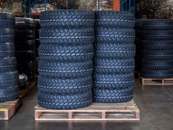 Stacks of tires on pallet in warehouse, tires for sale at a tire store.