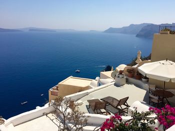 High angle view of buildings at santorini by blue sea