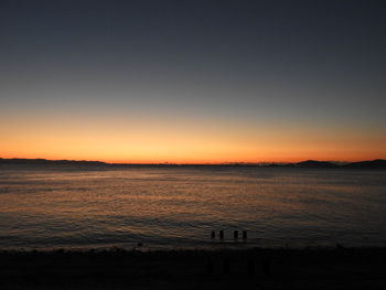 Scenic view of sea against clear sky during sunset