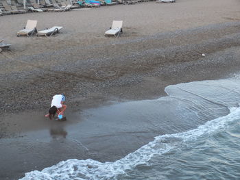 High angle view of people walking on beach